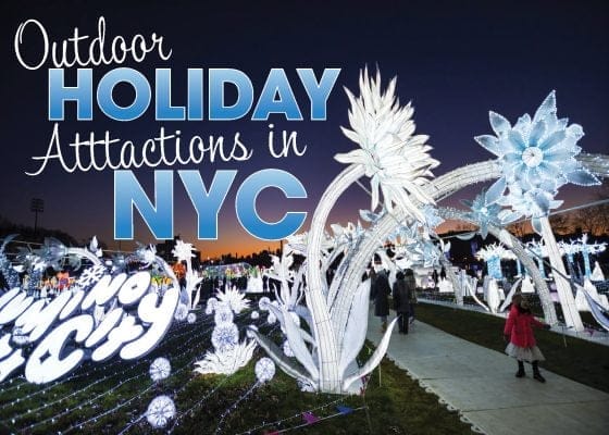 In Central Park at dusk, a festive outdoor holiday display features illuminated sculptures of large white and blue flowers and intricate designs. A person in a red coat strolls through the magical pathway, surrounded by various light installations that capture the citys enchanting spirit.