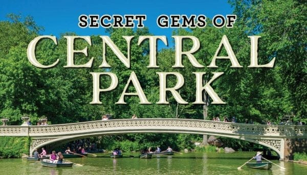 People are rowing boats on a lake under a stone bridge in Central Park, surrounded by lush green trees. Text over the image reads, Secret Gems of Central Park.